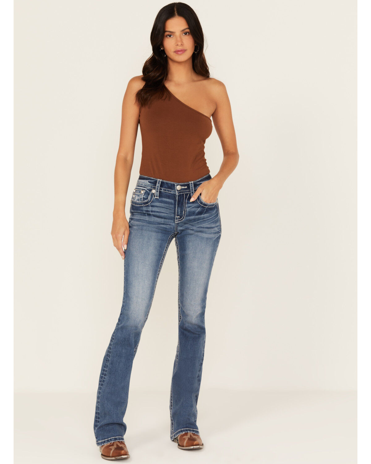 Product Name:  Miss Me Women's Medium Wash Mid Rise Fleur de Lis Pocket Bootcut Stretch Denim Jeans