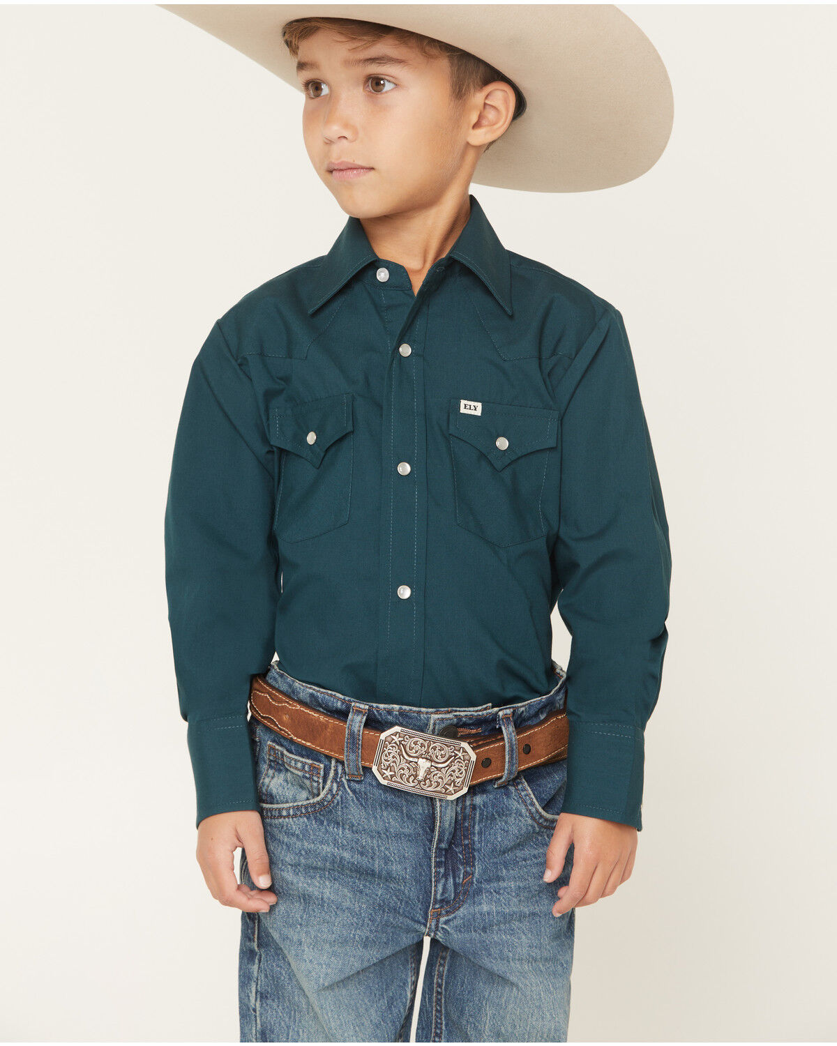 The product is a boys' shirt in solid teal color, matching the keyword perfectly.