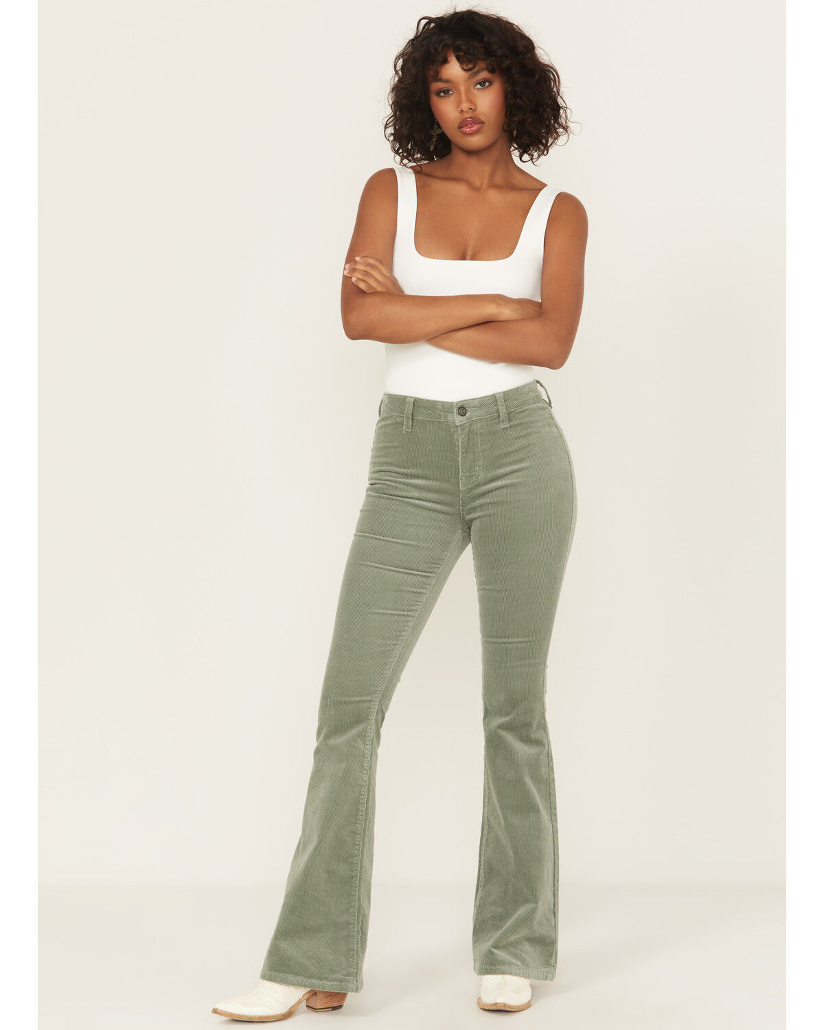 The product is a pair of green pants, specifically described as jade green corduroy jeans, which directly matches the keyword.