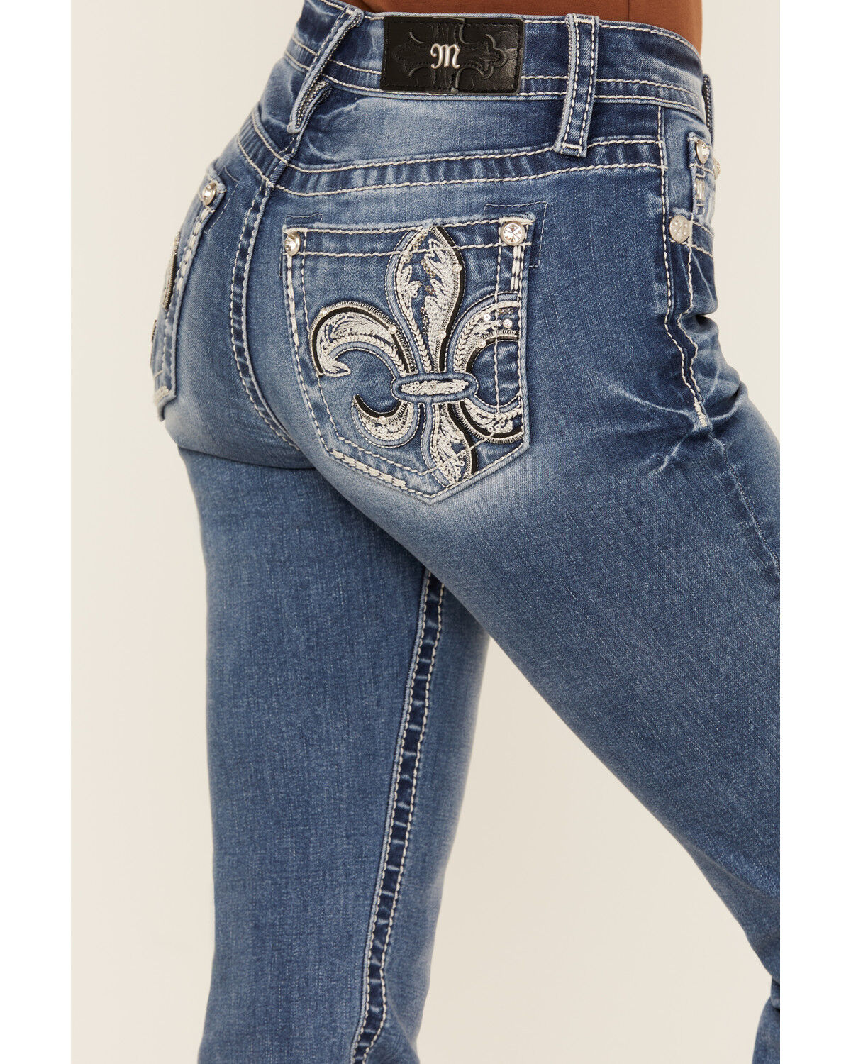 Product Name:  Miss Me Women's Medium Wash Mid Rise Fleur de Lis Pocket Bootcut Stretch Denim Jeans