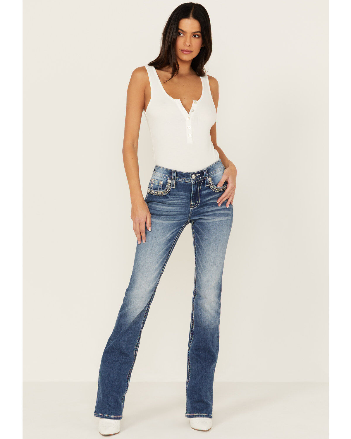 Product Name:  Miss Me Women's Medium Wash Mid Rise Border Flap Pocket Bootcut Stretch Denim Jeans